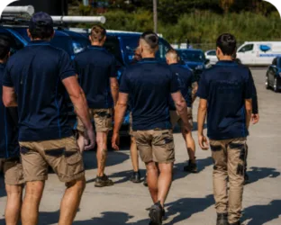 Plumbers walking to their service vans on a Dean Park job